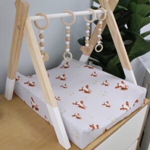 Neutral-toned changing mat cover with sage rainbow and sun motif—soft stretchy fabric for stylish and comfy diaper changes.