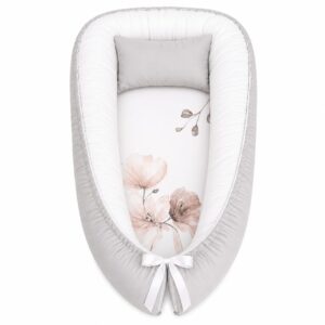 Pink Floral baby nest with padded raised sides and a small matching head pillow, designed to create a cozy, secure sleeping space for infants.