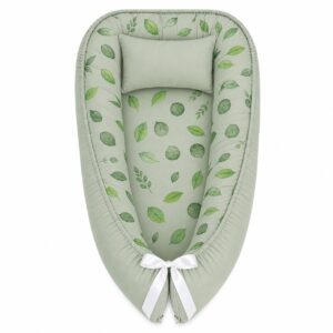 Cute Tree Leaf baby nest with padded raised sides and a small matching head pillow, designed to create a cozy, secure sleeping space for infants.