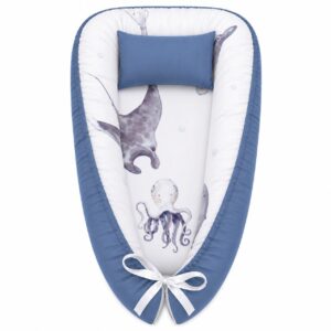 Under The Sea Mantaray baby nest with padded raised sides and a small matching head pillow, designed to create a cozy, secure sleeping space for infants.