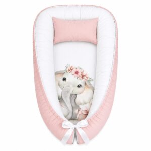 Boho Floral And Ellie Elephant baby nest with padded raised sides and a small matching head pillow, designed to create a cozy, secure sleeping space for infants.