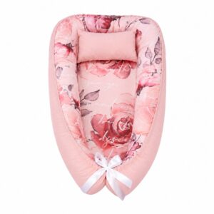 French Twist baby nest with padded raised sides and a small matching head pillow, designed to create a cozy, secure sleeping space for infants.