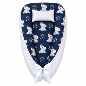 Navy Pennygum Ellie Elephant baby nest with padded raised sides and a small matching head pillow, designed to create a cozy, secure sleeping space for infants.