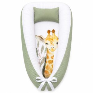 Sage Giraffe Leaf baby nest with padded raised sides and a small matching head pillow, designed to create a cozy, secure sleeping space for infants.