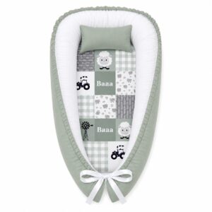Sage Green Farm baby nest with padded raised sides and a small matching head pillow, designed to create a cozy, secure sleeping space for infants.