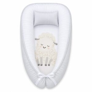 Boyish Rainbow Sheep baby nest with padded raised sides and a small matching head pillow, designed to create a cozy, secure sleeping space for infants.