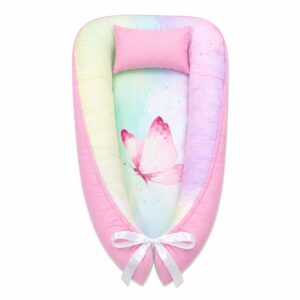 Colourful Butterfly baby nest with padded raised sides and a small matching head pillow, designed to create a cozy, secure sleeping space for infants.
