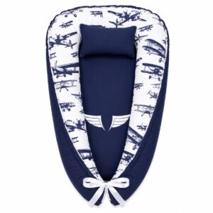 Adventure Awaits Simple Airplane Vintage baby nest with padded raised sides and a small matching head pillow, designed to create a cozy, secure sleeping space for infants.