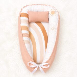Boho You Are Rainbow baby nest with padded raised sides and a small matching head pillow, designed to create a cozy, secure sleeping space for infants.