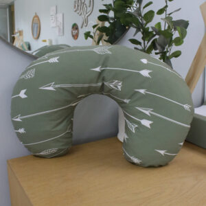 Handcrafted nursing pillow with inner, perfect for comfortable feeding and tummy time in a South African-inspired nursery. Cinnamon and Spice. Featuring green with arrows print
