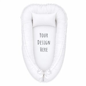 Custom Design baby nest with padded raised sides and a small matching head pillow, designed to create a cozy, secure sleeping space for infants.
