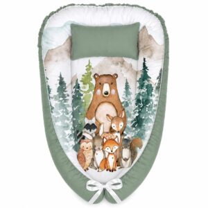 Woodlands Watercolor Dark Sage Green baby nest with padded raised sides and a small matching head pillow, designed to create a cozy, secure sleeping space for infants.