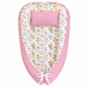 Floral Spring Garden baby nest with padded raised sides and a small matching head pillow, designed to create a cozy, secure sleeping space for infants.