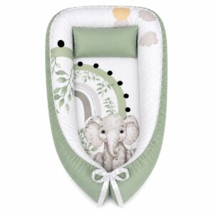 Rainbow Green Ellie baby nest with padded raised sides and a small matching head pillow, designed to create a cozy, secure sleeping space for infants.