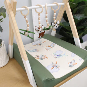 Handcrafted wooden baby gym with neutral tones and soft hanging toys, designed for sensory development and motor skills – locally made in South Africa. Ideal for changing tables and baby development. Airplane and Chihuahua Theme