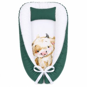 Cute Fluffy Cow Sleeping baby nest with padded raised sides and a small matching head pillow, designed to create a cozy, secure sleeping space for infants.