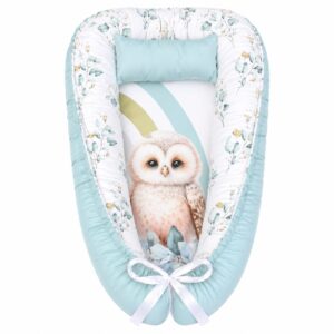 Rainbow Eucalyptus Owl baby nest with padded raised sides and a small matching head pillow, designed to create a cozy, secure sleeping space for infants.