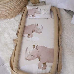 Printed baby nest / baby pod with matching pillow in Beige Rhino tones, offering a cozy, secure space for newborns – part of a handcrafted South African nursery set. Cinnamon and Spice