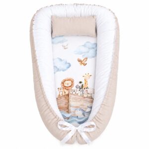 Noah’s Watercolour All Animals Ark baby nest with padded raised sides and a small matching head pillow, designed to create a cozy, secure sleeping space for infants.