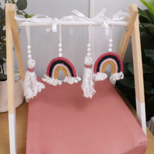 Natural wooden baby gym with minimalist wooden dangles hanging from frame. Brand: Cinnamon and Spice