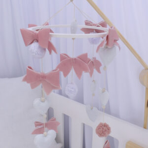 Cot mobile with dusty pink bows and white accessories, handcrafted for a calming and stylish baby nursery – Cinnamon and Spice Baby Boutique.