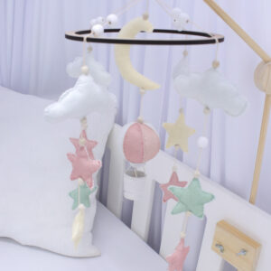 Cot mobile with pink hot air balloon, pastel moon, stars, and white clouds – handcrafted for dreamy nursery décor by Cinnamon and Spice Baby Boutique.