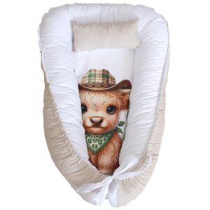 Cactus Highland Cow Boy baby nest with padded raised sides and a small matching head pillow, designed to create a cozy, secure sleeping space for infants.
