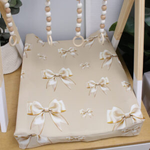 Handmade baby changing mat cover in soft, breathable fabric with a stylish print, fitted snugly on a standard changing mat, ideal for a modern nursery.
