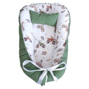 Checkered Dirt Bike Rust and Olive baby nest with padded raised sides and a small matching head pillow, designed to create a cozy, secure sleeping space for infants.