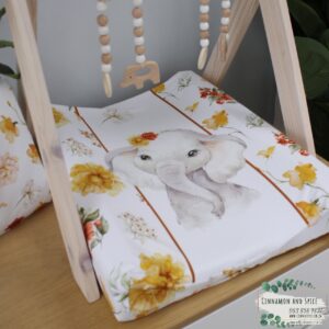 Neutral-toned changing mat cover with sage rainbow and sun motif—soft stretchy fabric for stylish and comfy diaper changes.