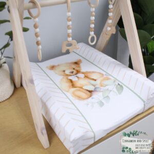 Neutral-toned changing mat cover with sage rainbow and sun motif—soft stretchy fabric for stylish and comfy diaper changes.