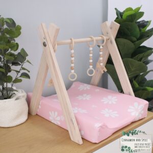 Neutral-toned changing mat cover with sage rainbow and sun motif—soft stretchy fabric for stylish and comfy diaper changes.