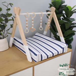 Neutral-toned changing mat cover with sage rainbow and sun motif—soft stretchy fabric for stylish and comfy diaper changes.