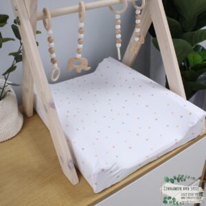 Neutral-toned changing mat cover with sage rainbow and sun motif—soft stretchy fabric for stylish and comfy diaper changes.