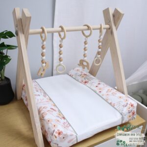 Neutral-toned changing mat cover with sage rainbow and sun motif—soft stretchy fabric for stylish and comfy diaper changes.