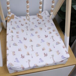 Neutral-toned changing mat cover with sage rainbow and sun motif—soft stretchy fabric for stylish and comfy diaper changes.