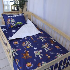 Toy Story-themed zipper bedding set for toddlers, custom made from ultra-soft, hypoallergenic material, shown neatly zipped on a toddler bed.