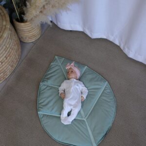 Leaf-shaped baby playmat with padded design, perfect for tummy time and nursery décor by Cinnamon and Spice Baby Boutique.