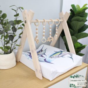 Neutral-toned changing mat cover with sage rainbow and sun motif—soft stretchy fabric for stylish and comfy diaper changes.