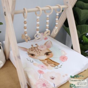 Neutral-toned changing mat cover with sage rainbow and sun motif—soft stretchy fabric for stylish and comfy diaper changes.
