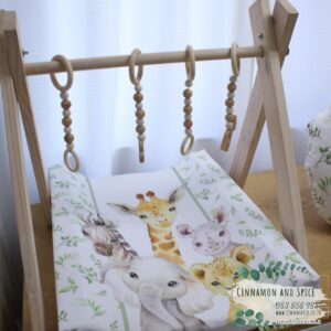 Neutral-toned changing mat cover with sage rainbow and sun motif—soft stretchy fabric for stylish and comfy diaper changes.