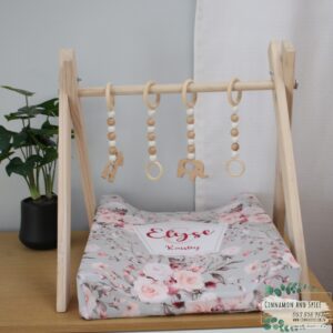 Neutral-toned changing mat cover with sage rainbow and sun motif—soft stretchy fabric for stylish and comfy diaper changes.