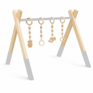 Minimalist natural wooden baby gym with hanging wooden toys on white background