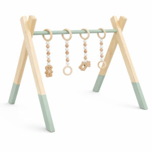 Minimalist natural wooden baby gym with hanging wooden toys on white background