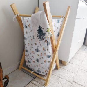 Handcrafted baby laundry basket with wooden frame featuring a floral peoni print – washable and foldable by Cinnamon and Spice