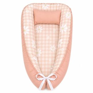 Boho Checkered Daisy Terracotta baby nest with padded raised sides and a small matching head pillow, designed to create a cozy, secure sleeping space for infants.