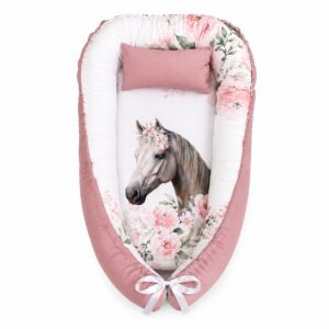 Wild White Horse Soft Rose baby nest with padded raised sides and a small matching head pillow, designed to create a cozy, secure sleeping space for infants.