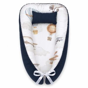 Vintage Airplane and Balloon baby nest with padded raised sides and a small matching head pillow, designed to create a cozy, secure sleeping space for infants.