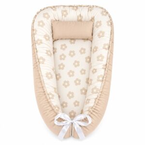 Daisy Natural Beige baby nest with padded raised sides and a small matching head pillow, designed to create a cozy, secure sleeping space for infants.